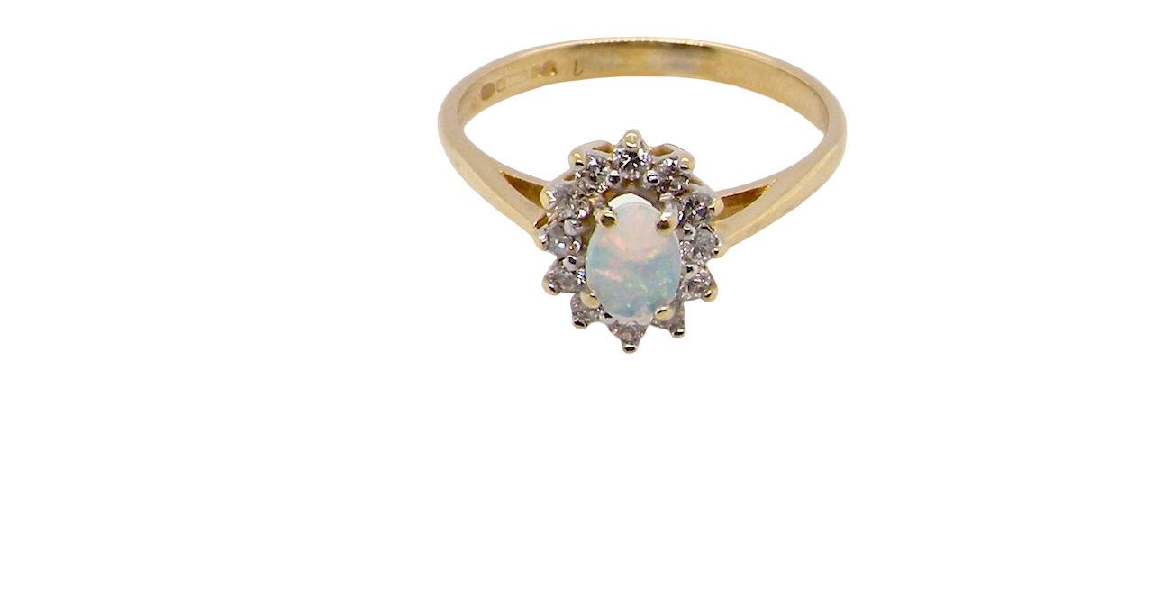 top view An elegant cluster ring featuring a white opal centre stone measuring 6 × 4mm, displaying a lively and attractive play of colour.