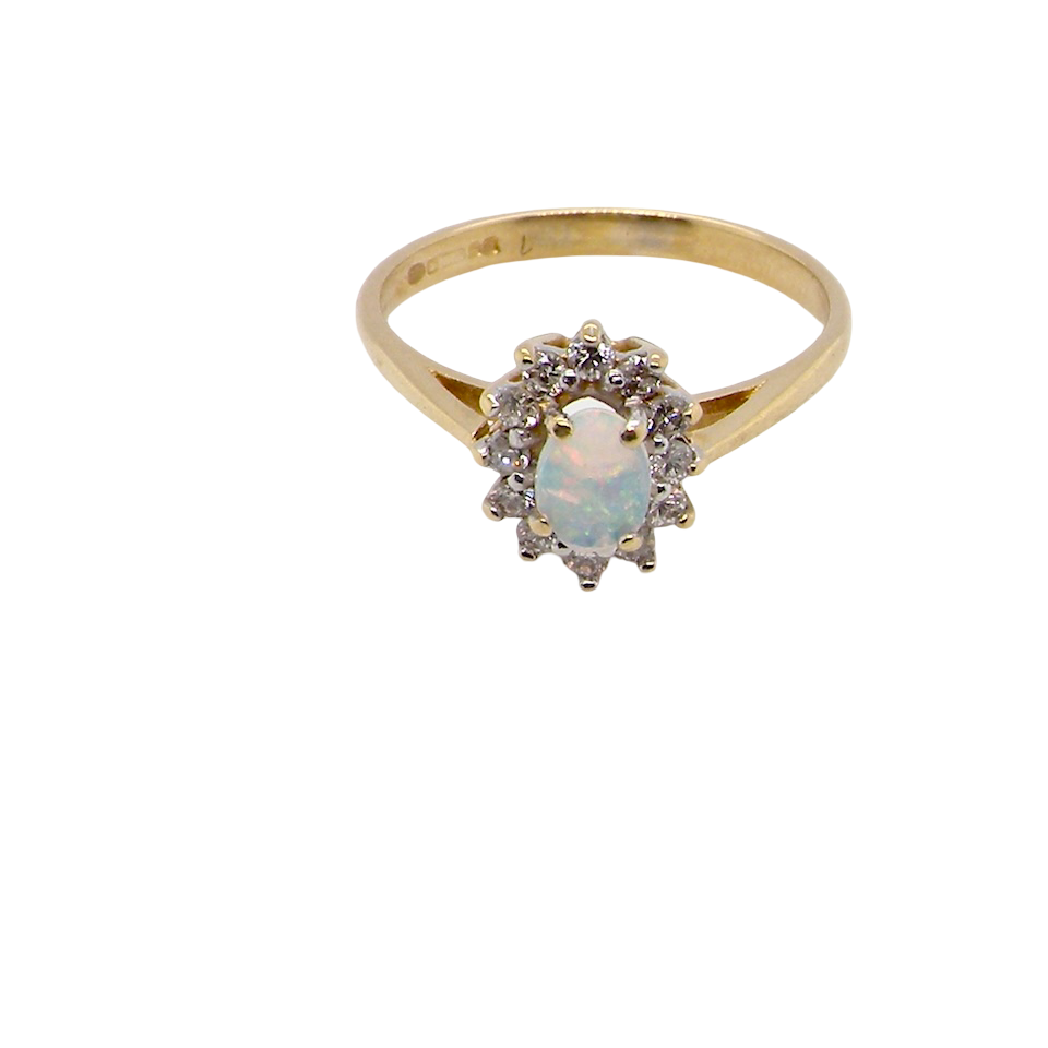 top view An elegant cluster ring featuring a white opal centre stone measuring 6 × 4mm, displaying a lively and attractive play of colour.