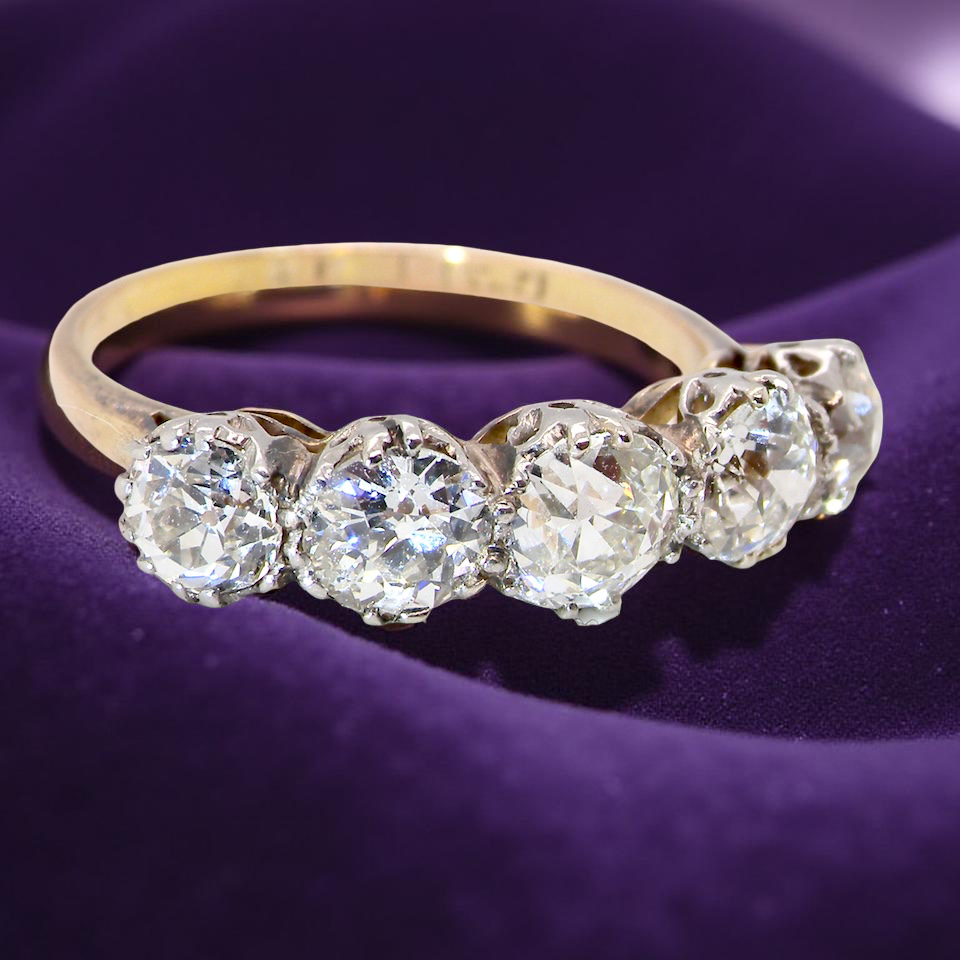 top view An impressive early 20th-century ring set with five old brilliant-cut white diamonds.