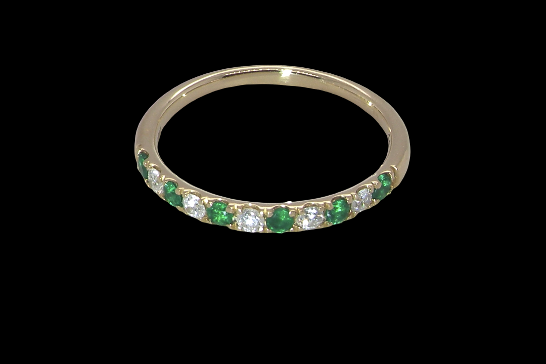 top view This ring is set with six bright green emeralds, each 2mm, (est 0.25 carats) and five 2mm brilliant cut white diamonds.