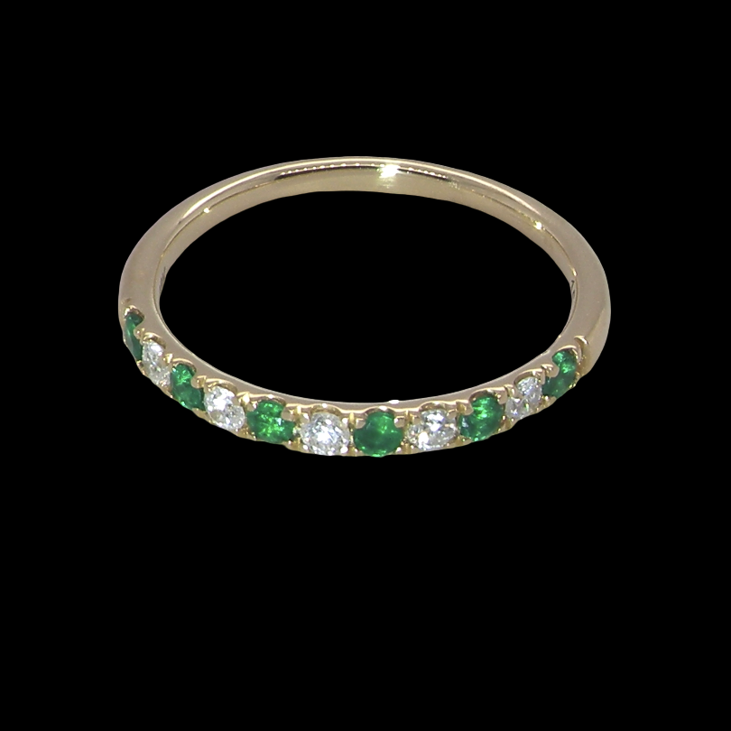 top view This ring is set with six bright green emeralds, each 2mm, (est 0.25 carats) and five 2mm brilliant cut white diamonds.