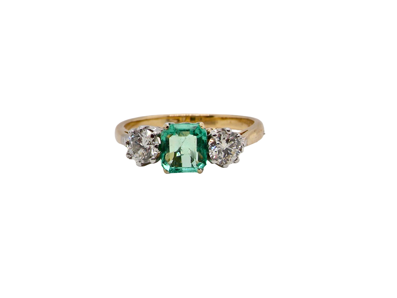 A vintage three stone Emerald and Diamond ring