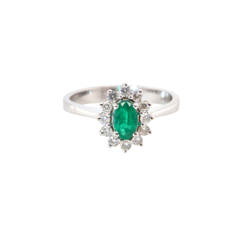 white gold cluster ring.
Centre stone is an oval cut emerald, 6x3.7mm (just under 0.50 carats)