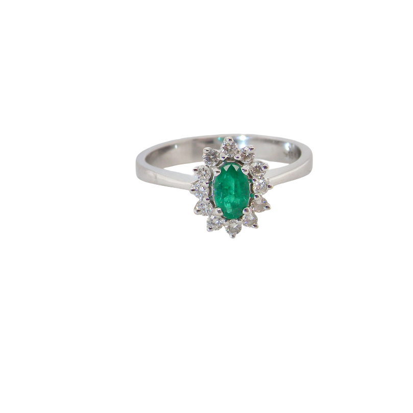 white gold cluster ring.
Centre stone is an oval cut emerald, 6x3.7mm (just under 0.50 carats) good deep green hue.