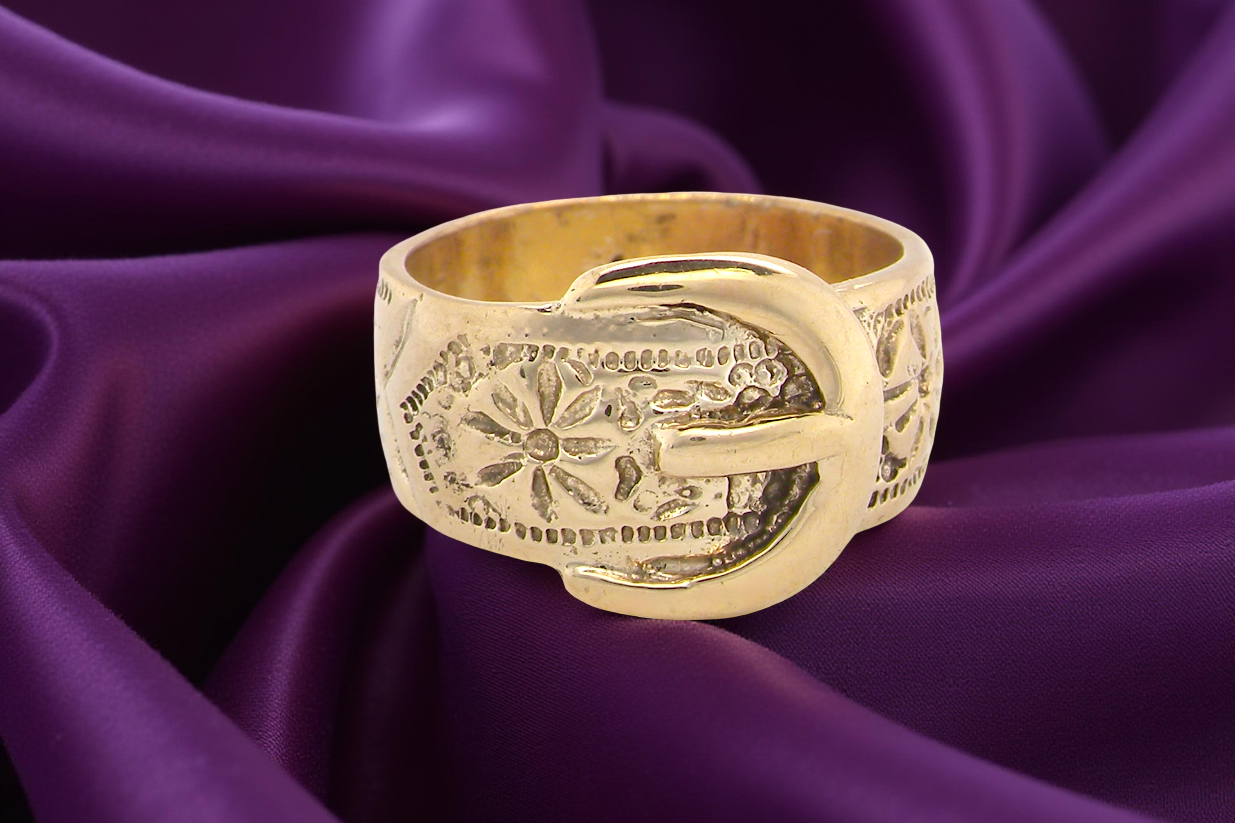 A wide gold buckle ring
