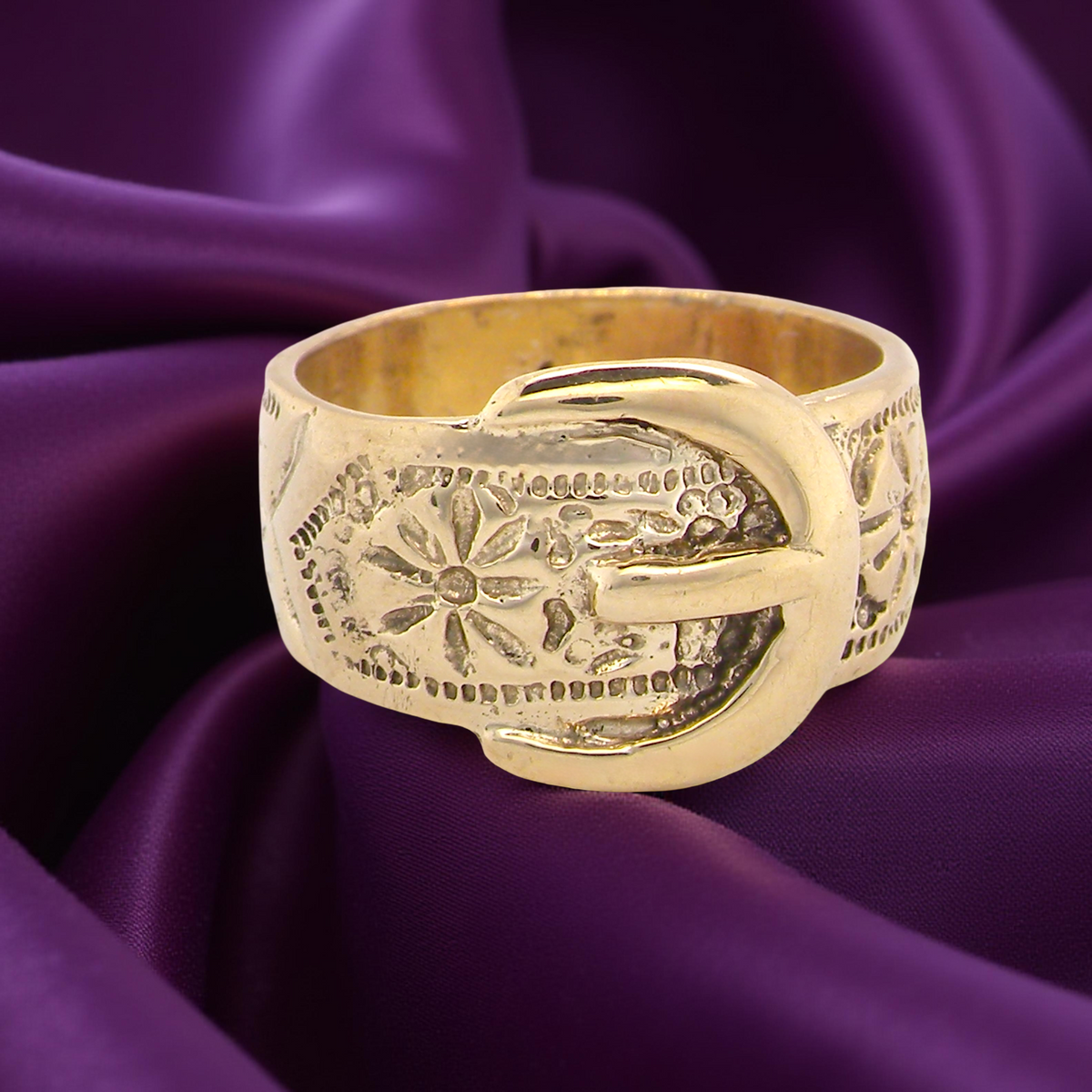 A wide gold buckle ring