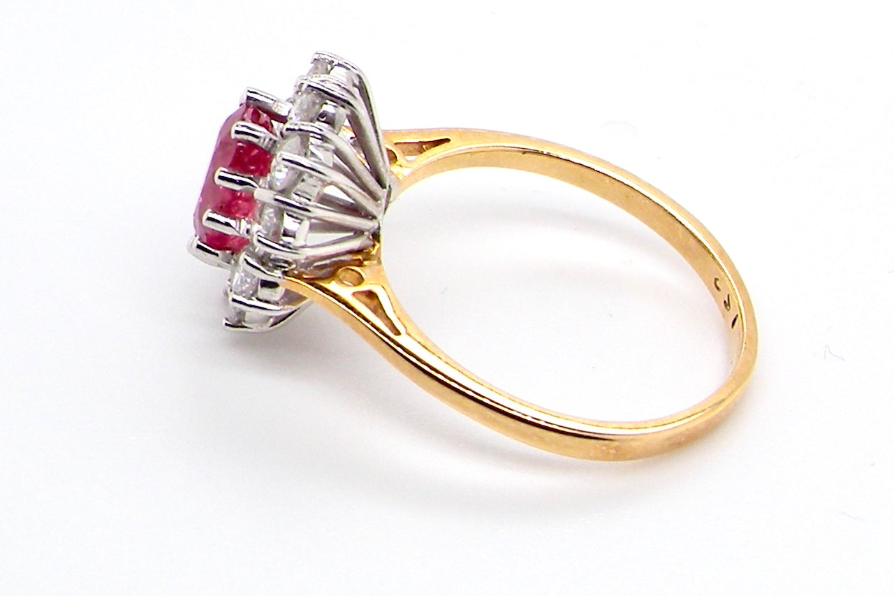 A classic cluster ring centred with an oval pinkish-red ruby measuring approximately 9 × 6 mm (estimated 1.75 carats)