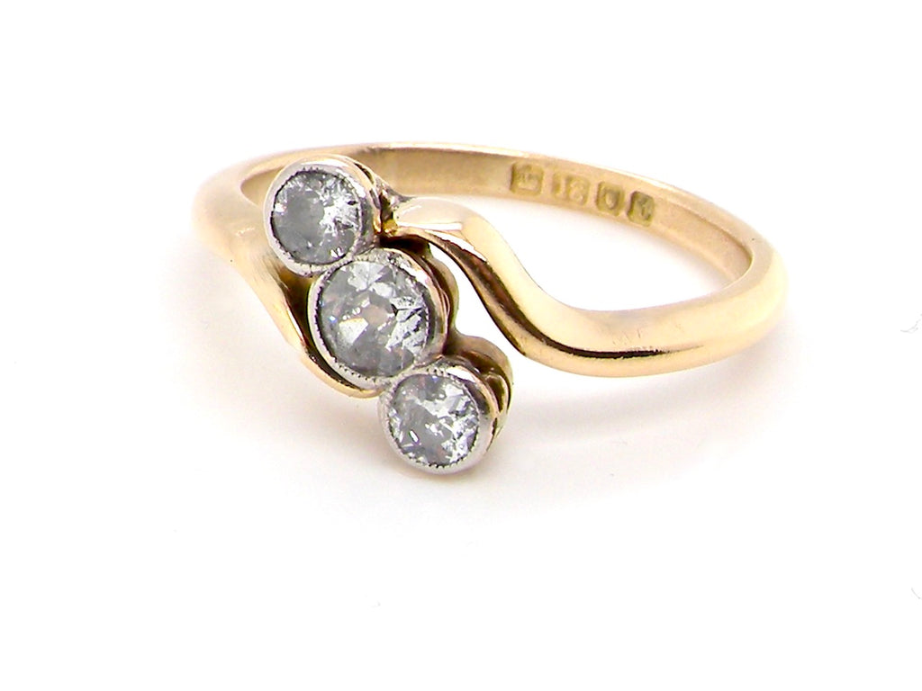 early 20th century vintage three stone diamond crossover style ring