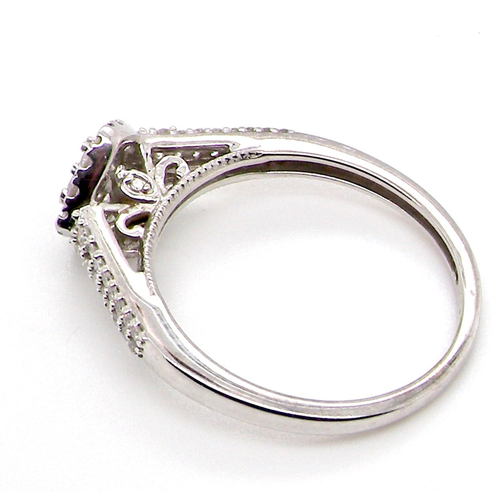 A 9 carat white gold diamond cluster ring side view