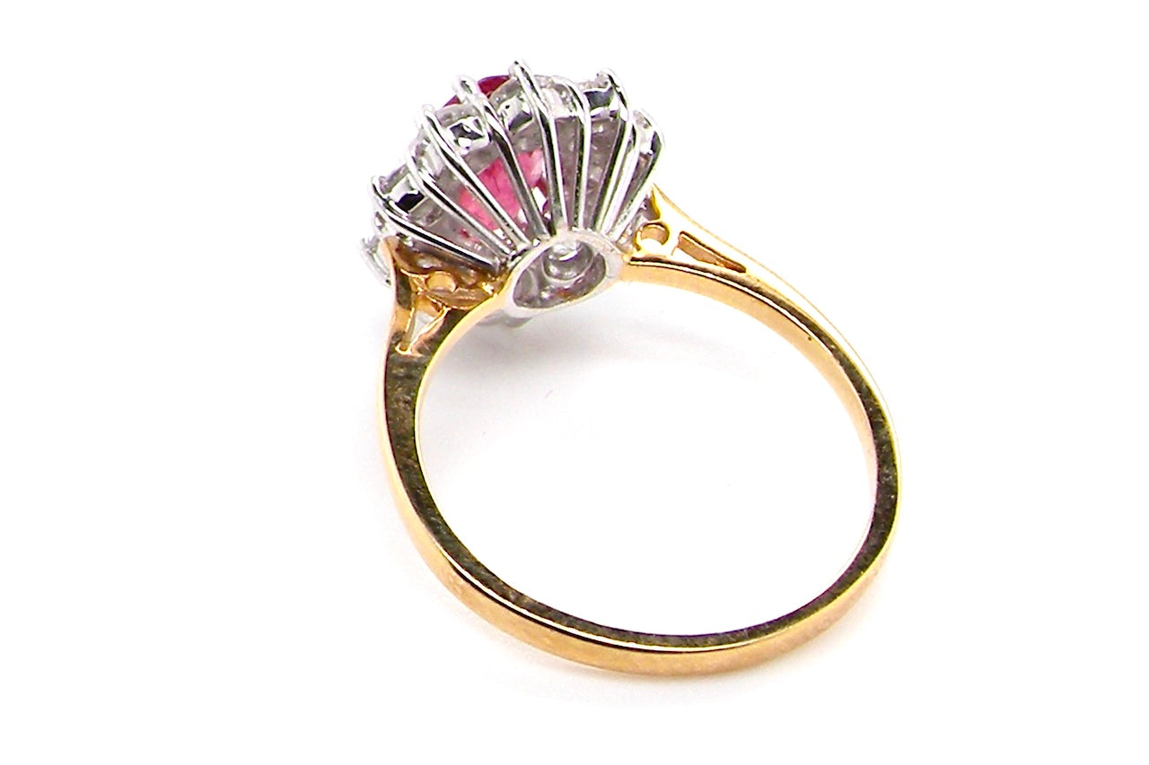 rear A classic cluster ring centred with an oval pinkish-red ruby measuring approximately 9 × 6 mm (estimated 1.75 carats)