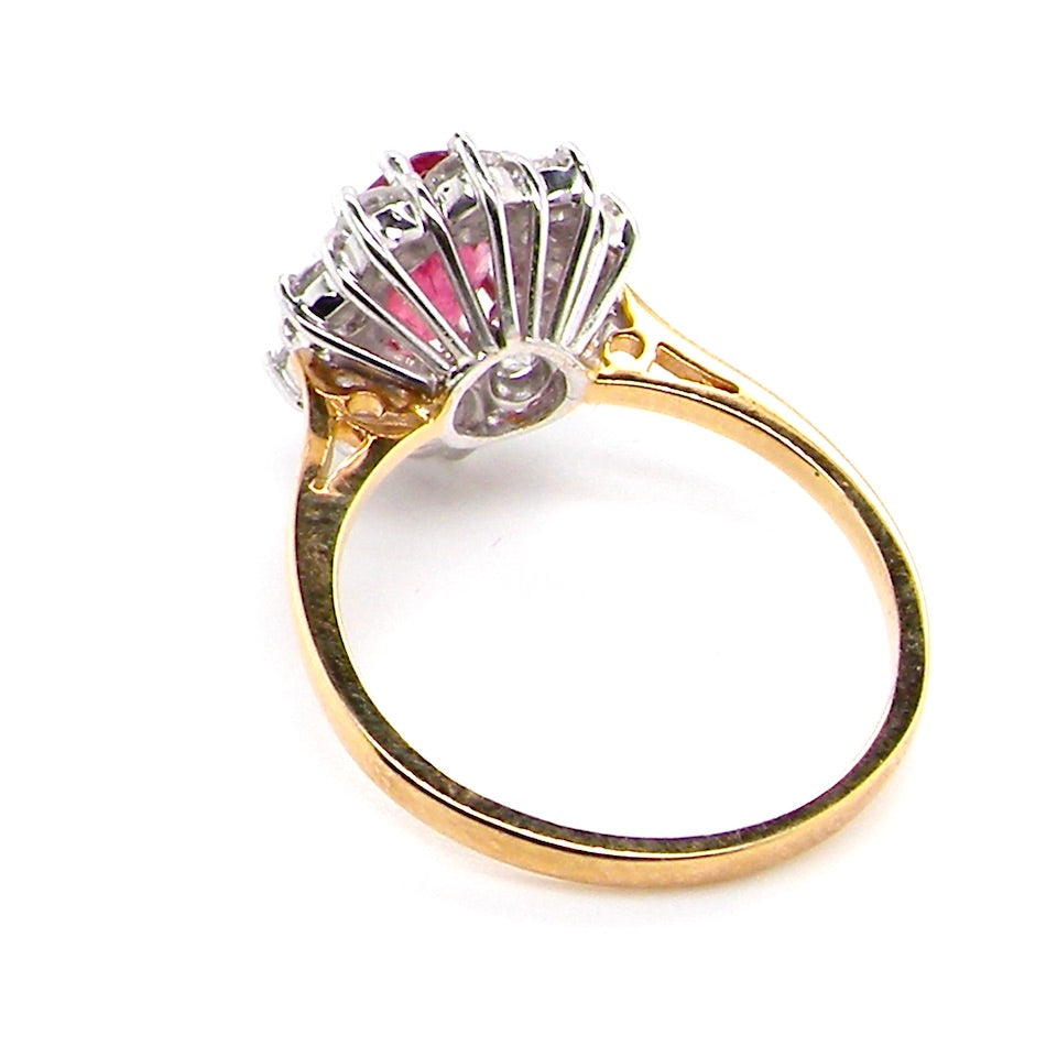 rear A classic cluster ring centred with an oval pinkish-red ruby measuring approximately 9 × 6 mm (estimated 1.75 carats)