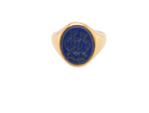  18 carat gold signet ring set with an oval lapis lazuli stone. This measures 12x9.5mm and has a carved intaglio seal engraved onto the stone. (These seem to be floral patterns)