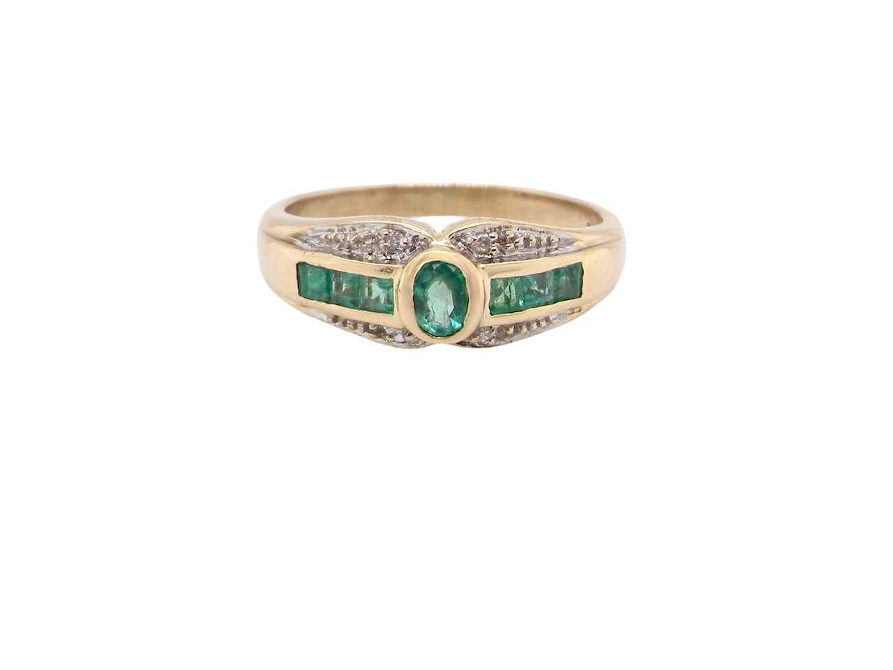 An emerald and diamond dress ring