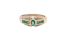 An emerald and diamond dress ring