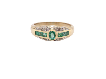 An emerald and diamond dress ring