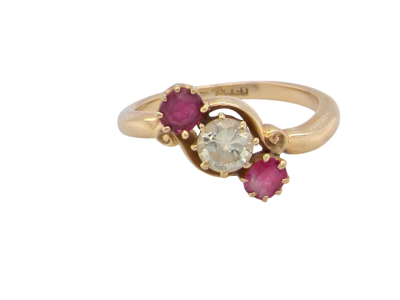 Gold ring with a central diamond and two rubies on a white background