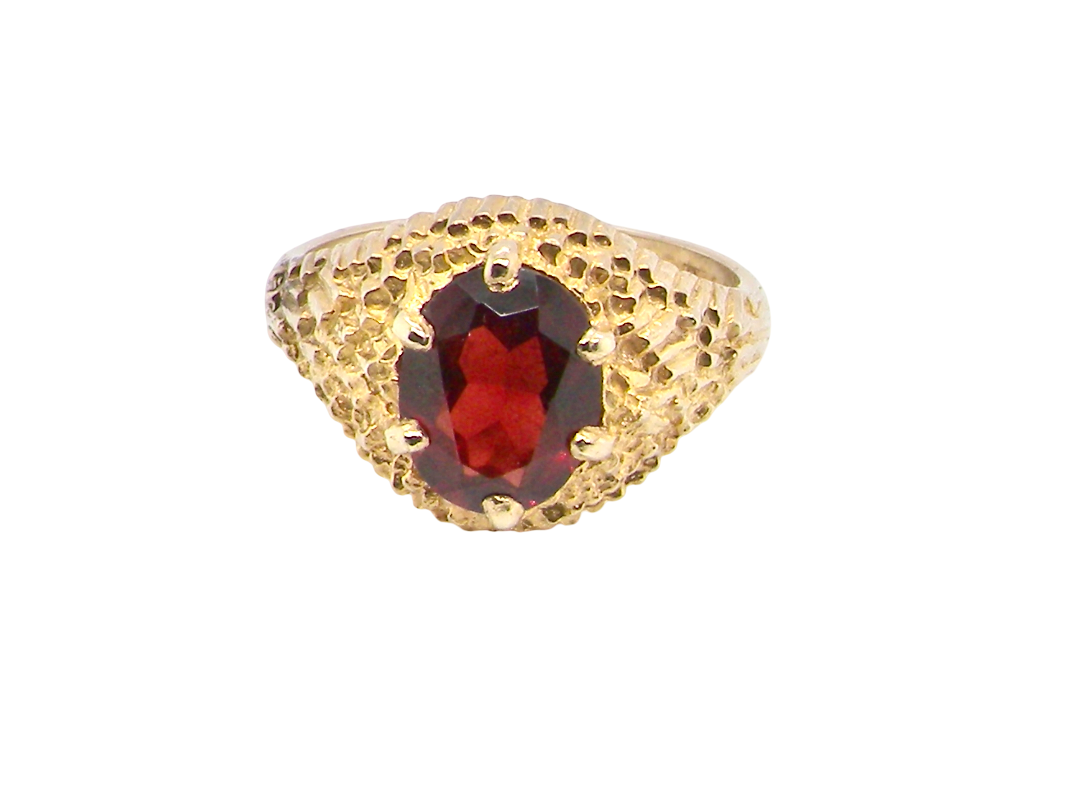 A 1970s dress ring set with an oval garnet stone. This measures 10x8mm 
