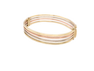 A 9 carat gold bangle. Solid bands of rose, yellow and white gold 