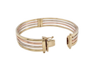 A 9 carat gold bangle. Solid bands of rose, yellow and white gold  9 carat