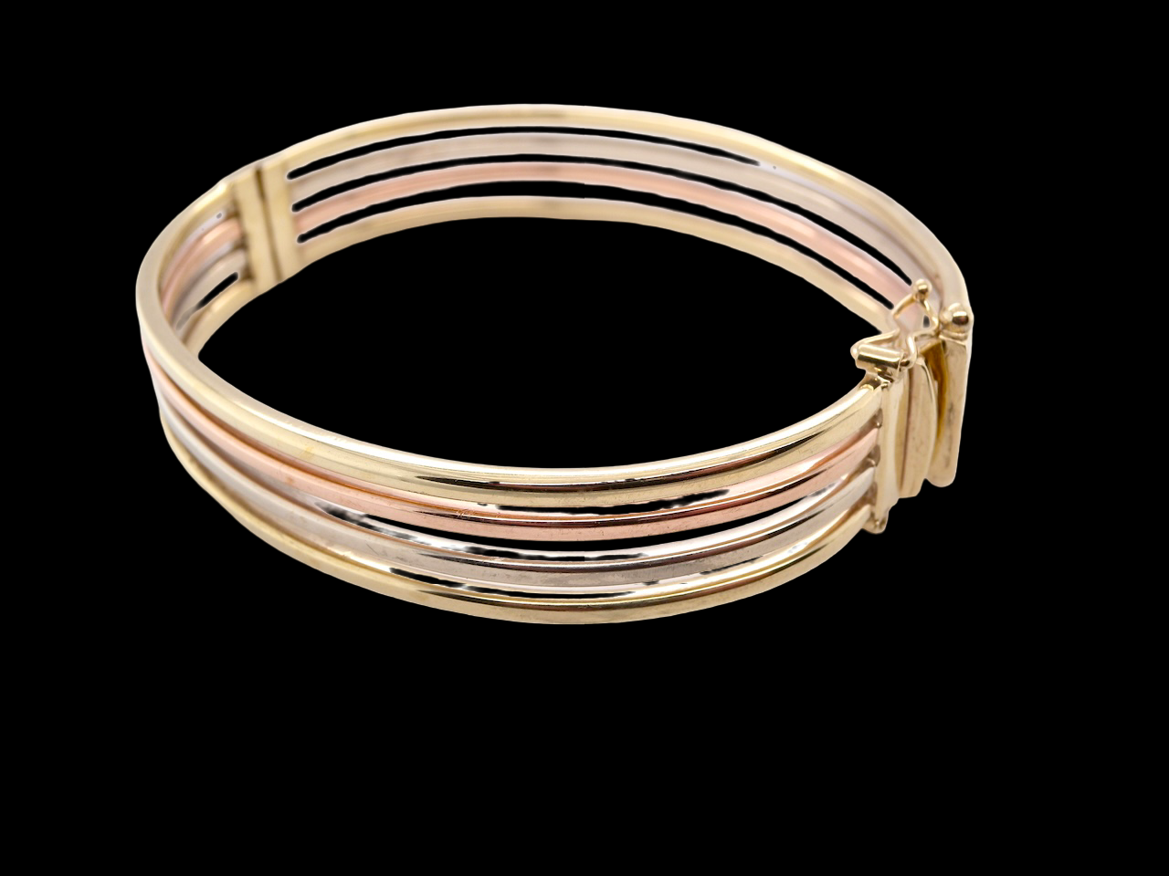 A 9 carat gold bangle with bands of rose, yellow and white gold 
