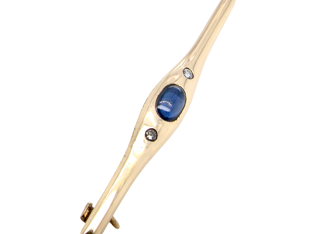 A 9 carat gold bar brooch, width 55mm. Set with a  sapphire,