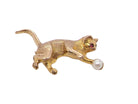 A 9 carat gold brooch in the shape of a cat chasing a ball.