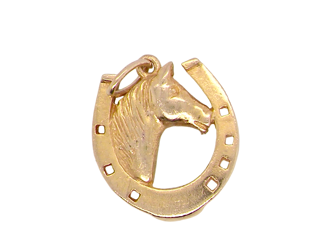 A 9 carat gold charm in the shape of a horseshoe with a horses head 