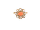 A 9 carat gold cluster ring. Centre stone an oval shaped coral stone 6x4mm.
