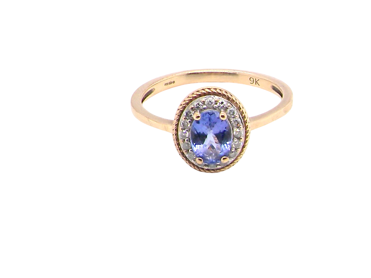 A 9 carat gold cluster ring. Features to the centre an oval cut tanzanite gem stone. Measures 7x5mm,