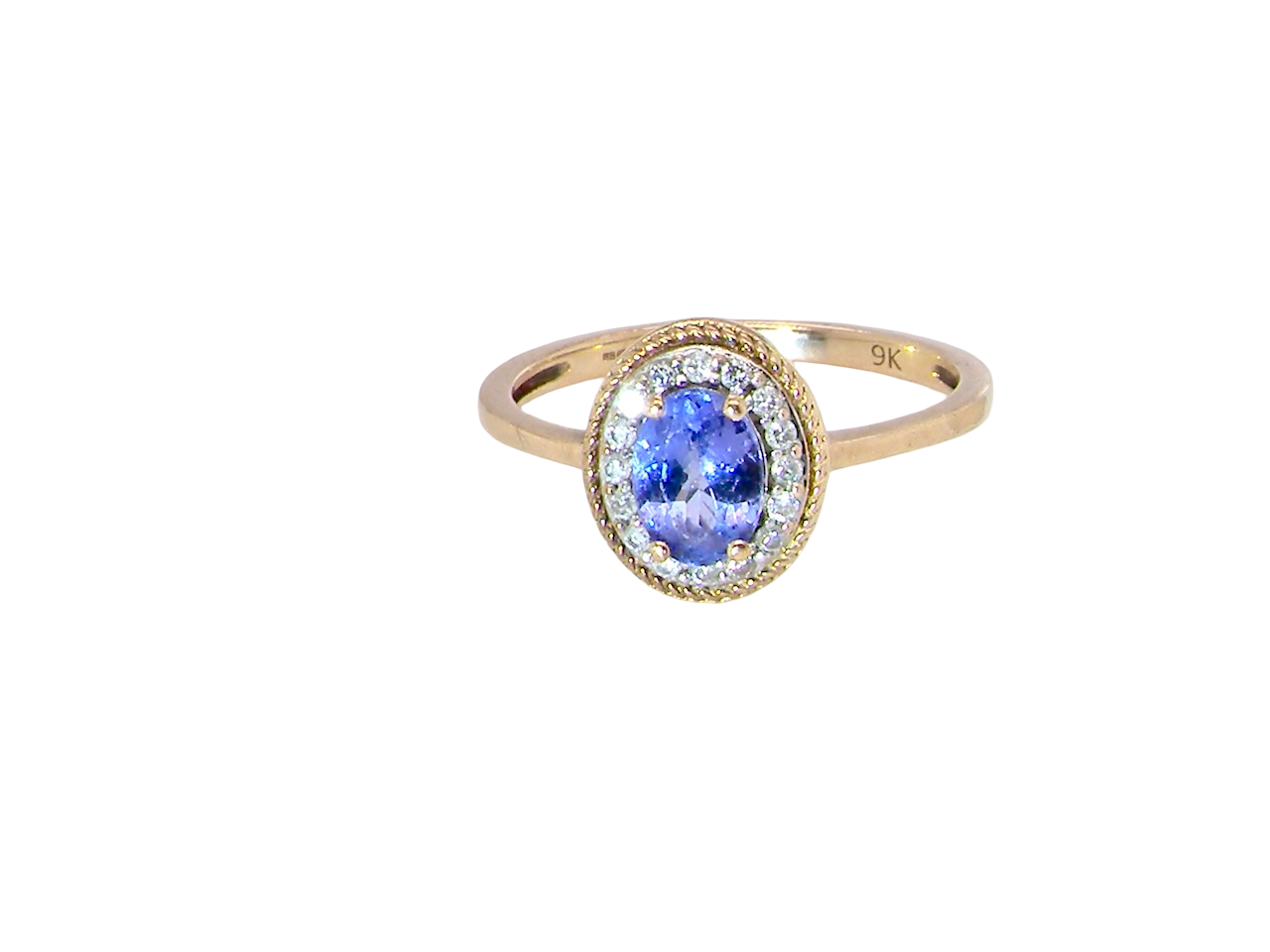 A 9 carat gold cluster ring. Features to the centre an oval cut tanzanite gem stone. Measures 7x5mm, four claw setting.