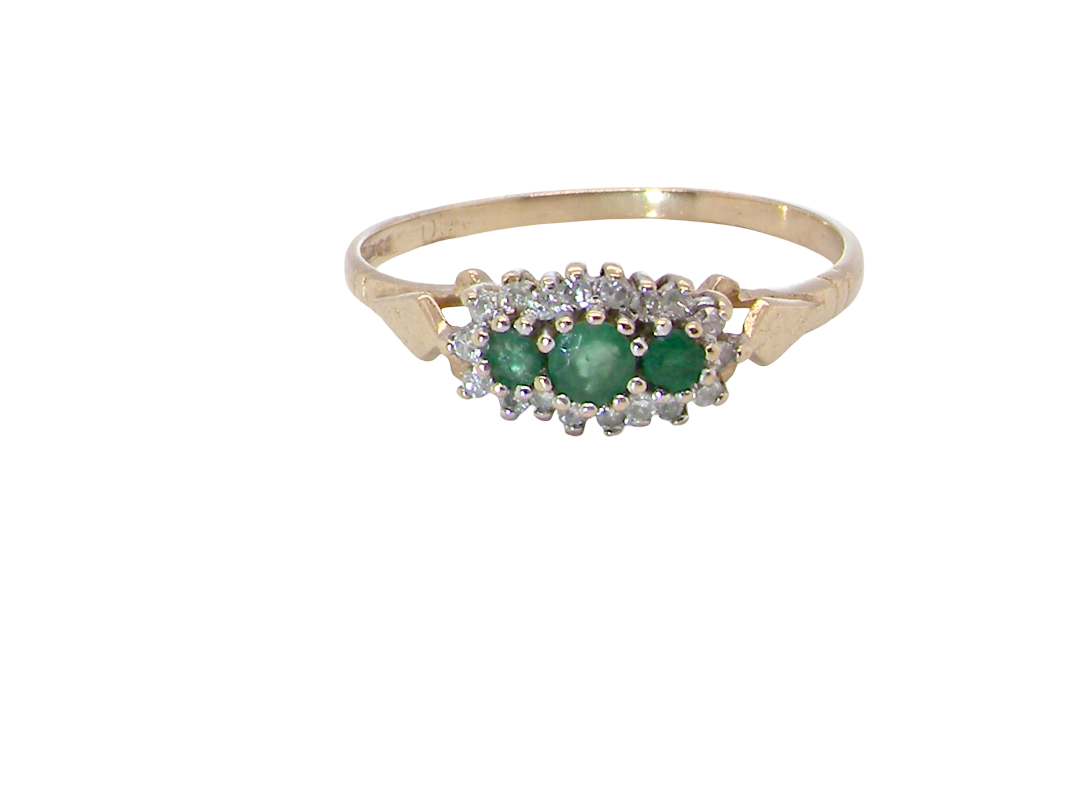 A 9 carat gold cluster ring. Set to the centre three round emeralds, centre 3.2mm, 