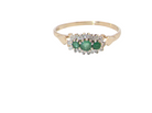 A 9 carat gold cluster ring. Set to the centre three round emeralds, centre 3.2mm, each side a 2.6mm stone.