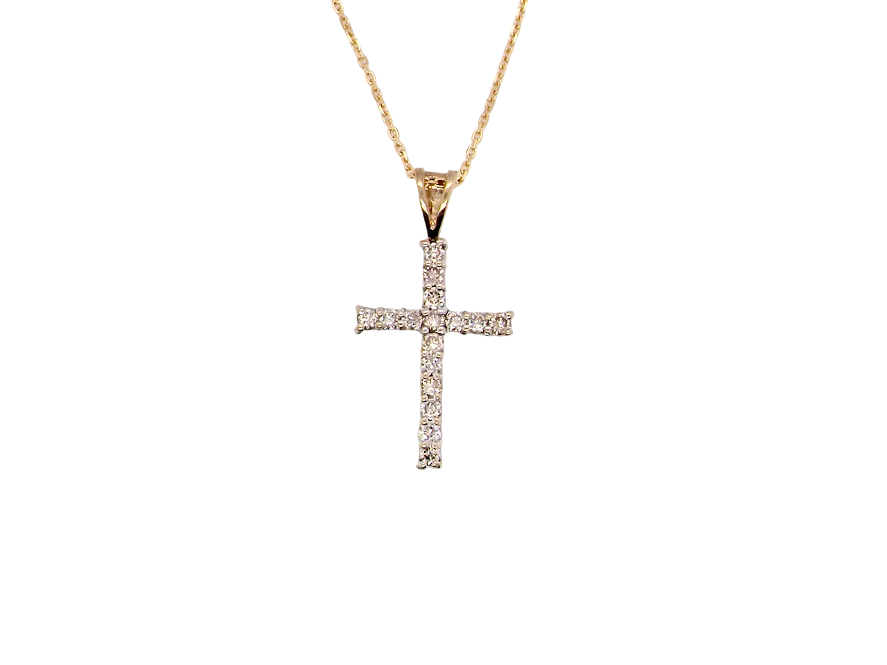 A 9 carat gold cross pendant. Set with fifteen small brilliant cut white diamonds.

Each 1.6mm, total carat weight estimated at 0.30 carats. Colour i-k, clarity Si. Overall size 18x12.5mm. 