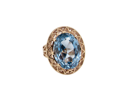 An oval-cut light blue gemstone ring set in a rose gold filigree halo, shown on a plain white background.