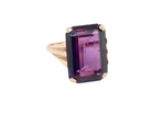 A 9 carat gold* dress ring that is set with a an amethyst gemstone.