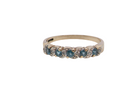 A 9 carat gold half hoop eternity ring. Set with five blue topaz gem stones, each 2.8mm.&nbsp;
