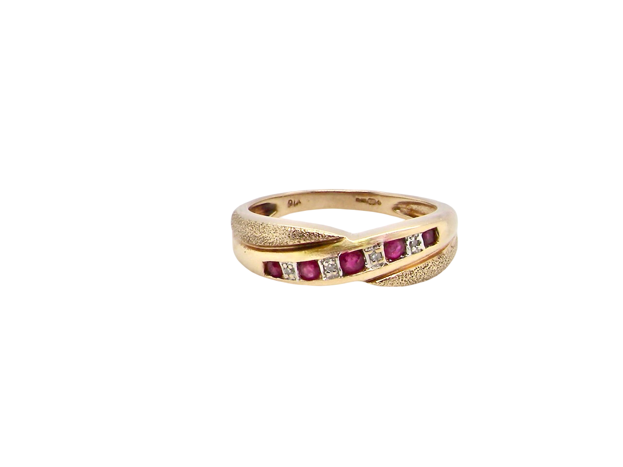 A 9 carat gold half hoop eternity ring. Set with five calibre cut rubies, from 1.7 to 2mm, and between small 1mm white diamonds.
