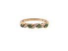A 9 carat gold half hoop eternity ring. Set with four 2.4mm emeralds.

Set in alternate sections, a 'lazy S' design,
