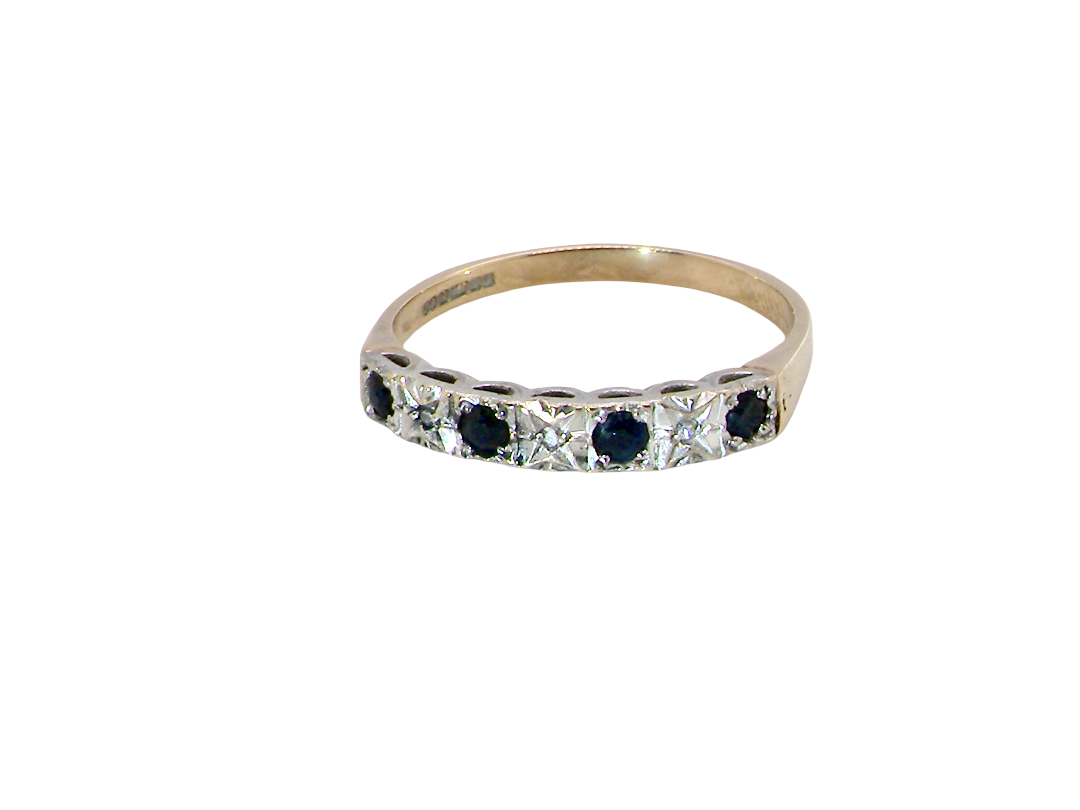 A 9 carat gold half hoop eternity ring. Set with four sapphires, each 2.4mm, and between each a 1mm illusion set diamond.