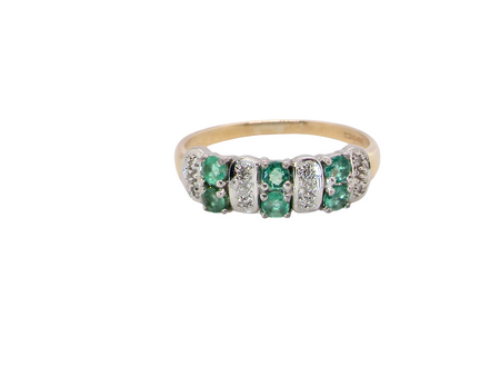 A 9 carat gold half hoop ring. Set with six round emeralds 3mm each,(total 0.35 carats est) and interspaced with vertical white gold sections each set with 1mm diamonds.(0.05 carats est)