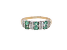 A 9 carat gold half hoop ring. Set with six round emeralds 3mm each,(total 0.35 carats est) and interspaced with vertical white gold sections each set with 1mm diamonds