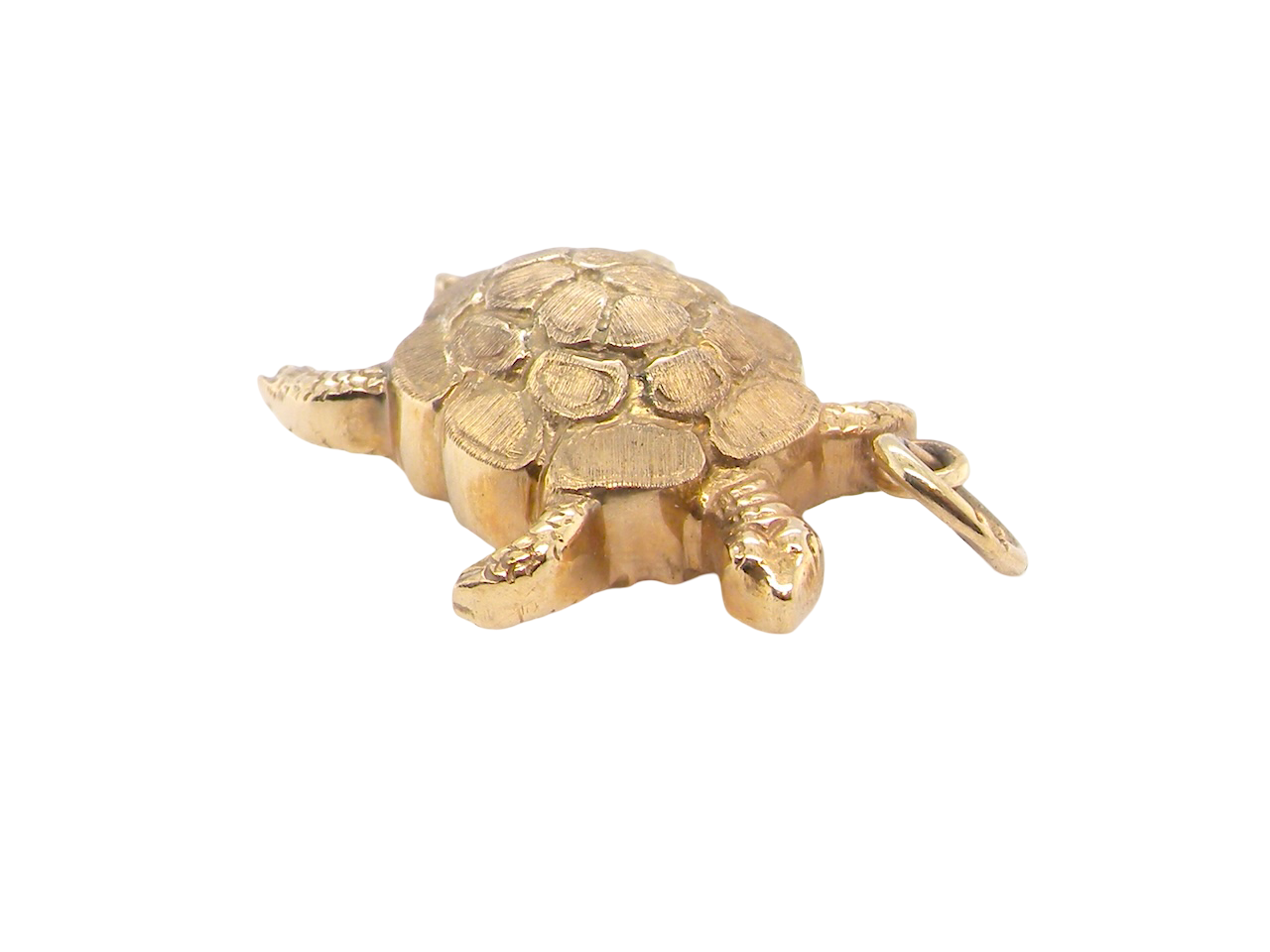 Gold turtle charm on a white background