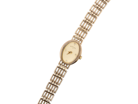 A 9 carat gold wrist watch by Rotary. Oval dial with a diamond dot at the 12. Champagne coloured dial.