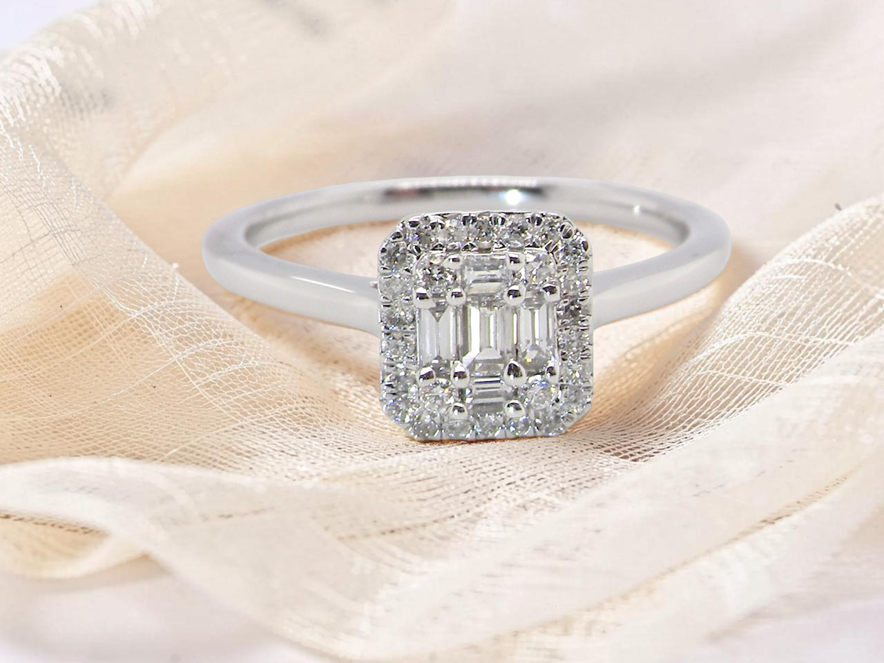 A 9 carat white gold cluster ring. The centre is set with five baguette cut white diamonds, 
