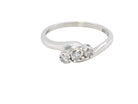 A 9 carat white gold cross over style trilogy ring. Three x 0.10mm diamonds, 