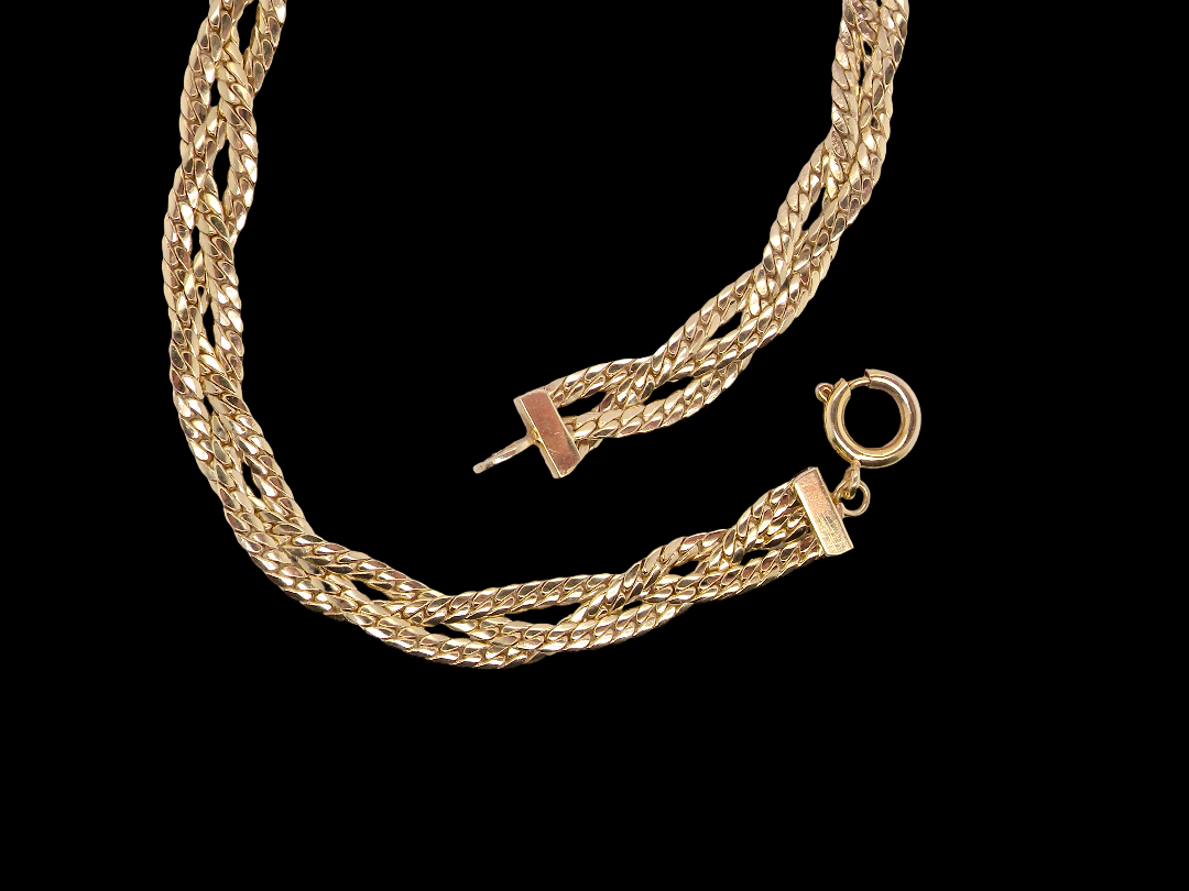 A 9 carat yellow gold bracelet. Plait design of two flat herringbone strands that weave 