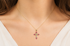 A 9ct gold ruby cross on model