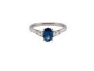 A Blue Topaz and Diamond 3 stone ring