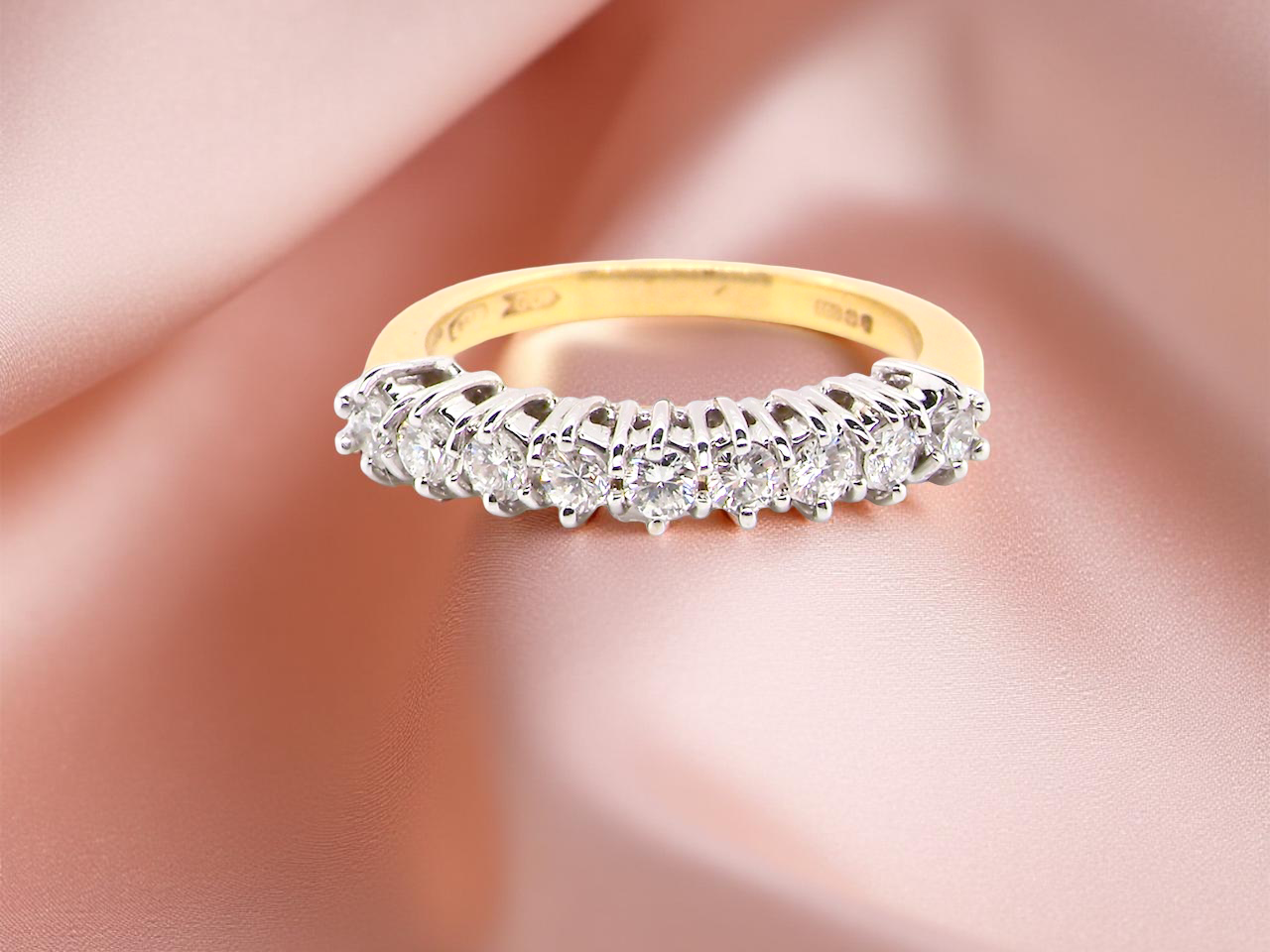 An 18ct gold diamond half eternity ring