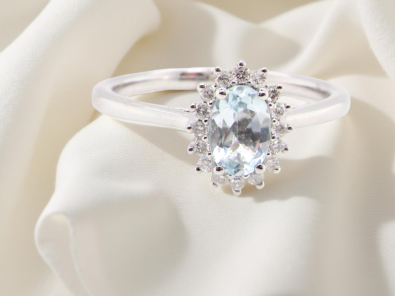 A NEW blue topaz and diamond ring